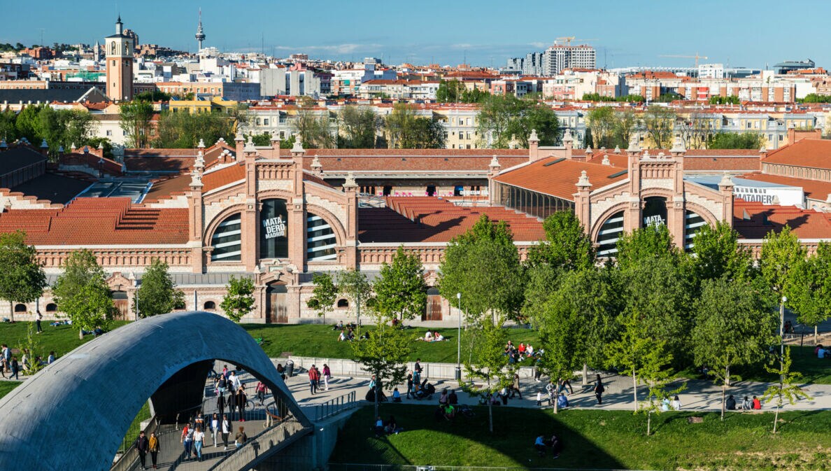 Stadtpanorama mit Personen vor einem Kulturzentrum in Madrid.