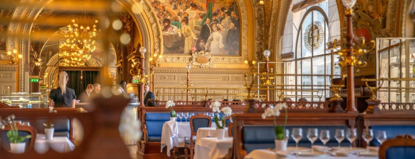 Prachtvoller Speisesaal mit goldenem Stuck sowie Wand- und Deckengemälden.