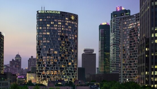 Beleuchtete Skyline mit Wolkenkratzern bei Abenddämmerung.