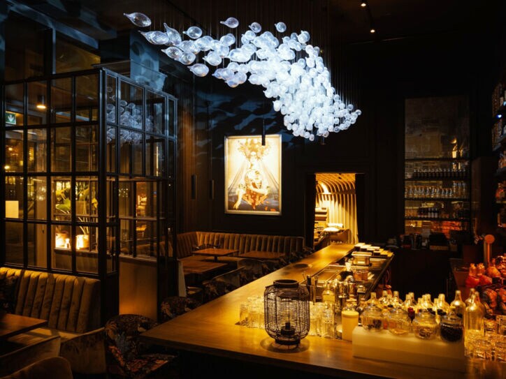 Gemütliches Restaurant mit Bar bei gedimmter Beleuchtung.