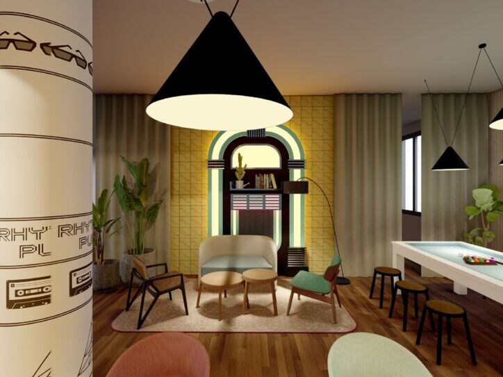 Ein moderner Aufenthaltsraum des Avani Frankfurt City Hotels mit verschiedenen bunten Stühlen, einem weißen Pool-Table und einer leuchtenden Jukebox-Dekoration.