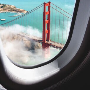 Blick aus einem Flugzeugfenster hinunter auf die Golden Gate Bridge