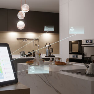 Blick in eine Küche, im Vordergrund steht ein Tablet, über das mehrere Elemente gesteuert werden können