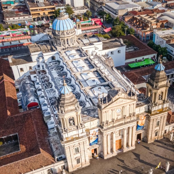 Luftaufnahme der Kathedrale von Guatemala-Stadt mit zwei Glockentürmen und blauem Kuppeldach im Stadtzentrum