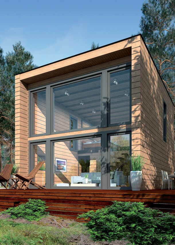 Ein modernes Blockhaus mit bodentiefer Glasfront und Terrasse im Wald