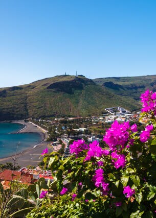 Blick auf die Bucht von Playa de Santiago mit pinken Blumen im Vordergrund