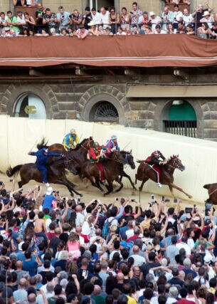 Reiter und Publikum beim Pferderennen Palio di Siena auf dem mittelalterlichen Platz der Stadt