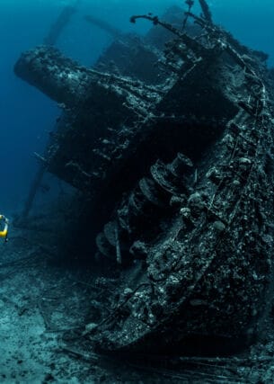 Taucher fotografiert das Wrack eines großen versunkenen Schiffes im Meer
