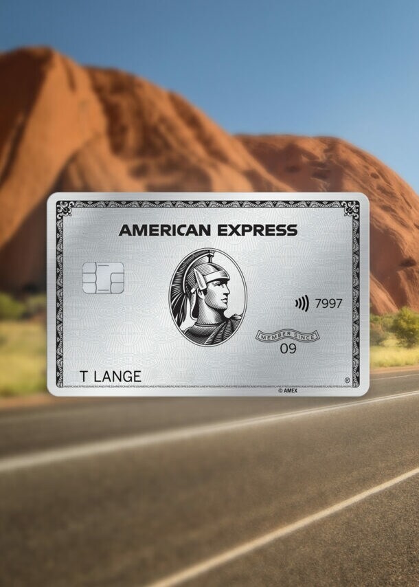 Eine Schnellstraße in einer Steppenlandschaft mit einem roten Felsen und einem Warnschild mit Känguru-Motiv.