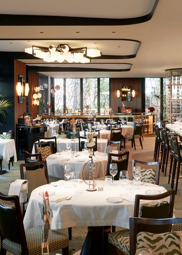 Edler Speisesaal mit eingedeckten Tischen und Barbereich in einem Luxusrestaurant.