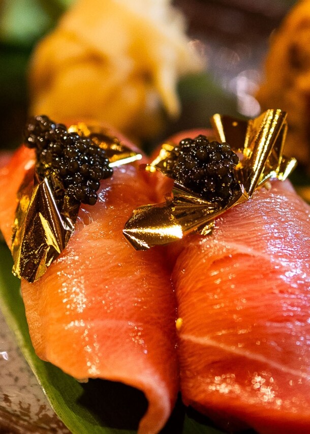 Nahaufnahme von edel angerichtetem Sashimi Sushi mit Blattgold und Kaviar.