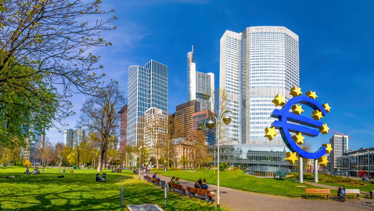Die Europäische Zentralbank in Frankfurt am Main mit einem Eurozeichen davor.