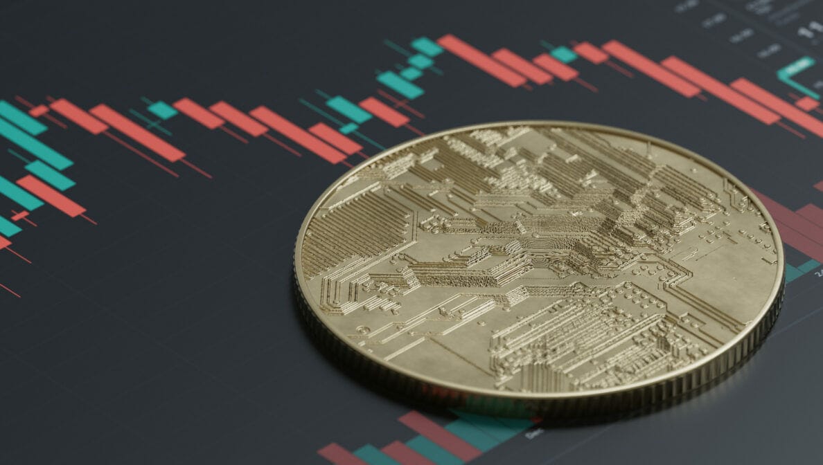 Eine Münze liegt auf einer Illustration von Börsenkursen
