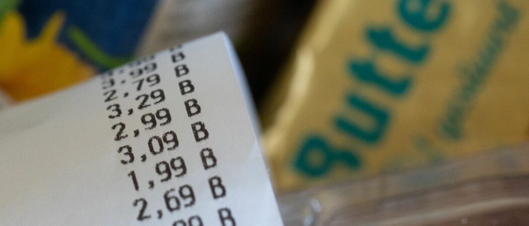 ILLUSTRATION - Ein Kassenzettel liegt auf einer Einkaufskiste mit Lebensmitteln. (zu dpa: «Inflationsrate in Eurozone sinkt leicht»)