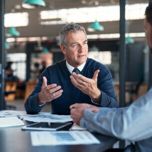 Zwei Männer unterhalten sich im Büro.