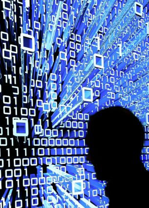 Ein Messebesucher geht an einem Leuchtdisplay auf der CeBIT vorbei. (zu dpa: «Bitkom und SAP: KI ist Chance, kein Job-Killer»)