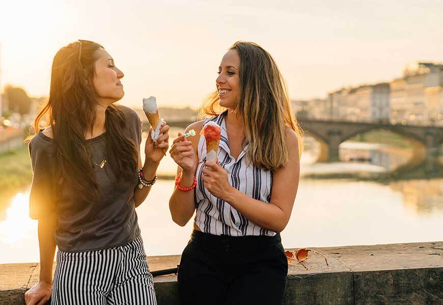 Woman paying with Tap to Pay at restaurant with friends