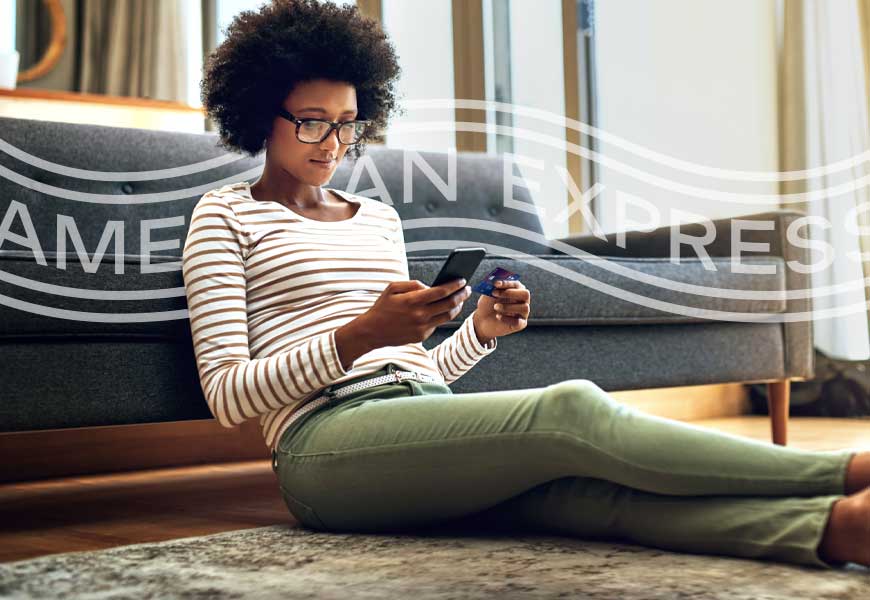 Woman on couch with Card looking at phone