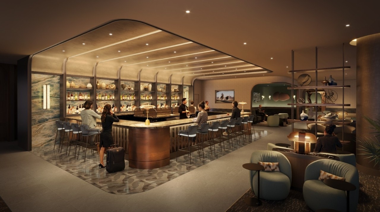 Rendering of the expanded Centurion Lounge at Dallas Fort Worth International Airport featuring a large central bar with warm lighting, expanded seating, and a second full-service bar area, with travelers relaxing and enjoying drinks in an upscale, contemporary space.