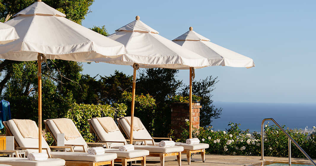 Soak in the California sunshine beside our serene hillside pool, where sweeping ocean views and gentle coastal breezes set the tone for pure