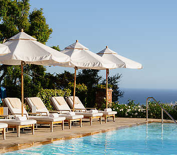 Soak in the California sunshine beside our serene hillside pool, where sweeping ocean views and gentle coastal breezes set the tone for pure
