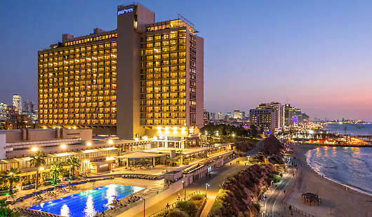 The Vista at Hilton Tel Aviv at sunset: rooms with sea views, exclusive hotel, outdoor pool, and beach minutes away – pure elegance.
