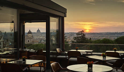 Hotel Eden's Il Giardino Ristorante Open air terrace during sunset by Dorchester Collection