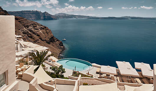 Infinity-edge pool hanging from the cliffs of Oia