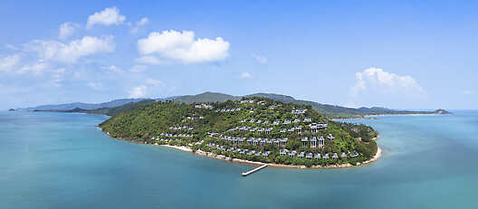Aerial drone view of Conrad Koh Samui, showcasing its private pool villas, lush tropical surroundings, and panoramic ocean views.