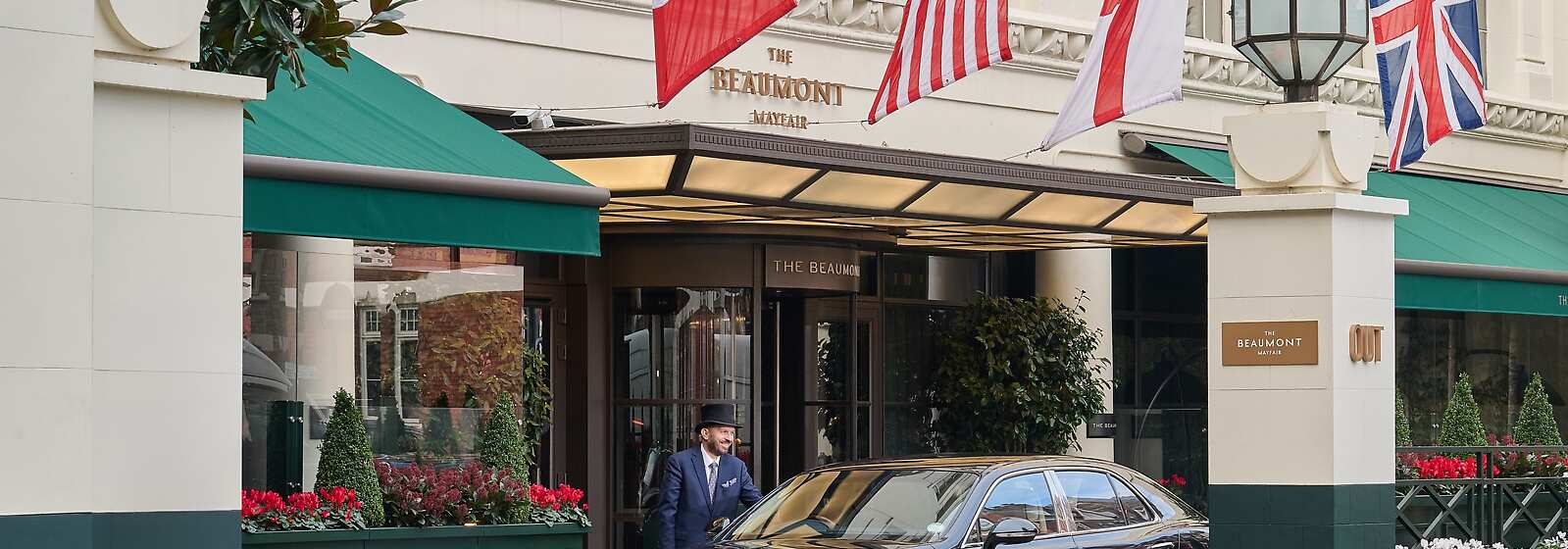 Hotel exterior with hotel car and doorman