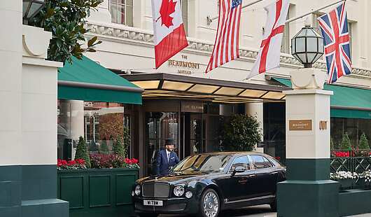 Hotel exterior with hotel car and doorman