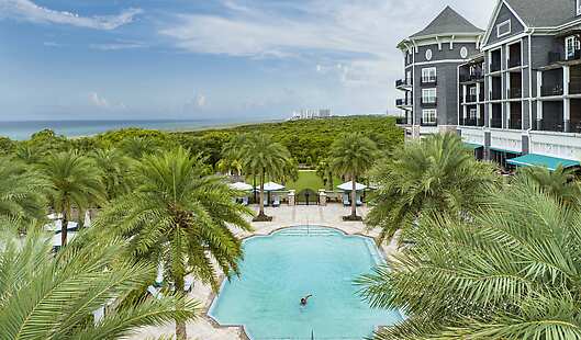View of the resort hotel that overlooks the Adults-Only Pool, Grand Lawn, and neighboring State Park and Emerald-water Gulf Coast.