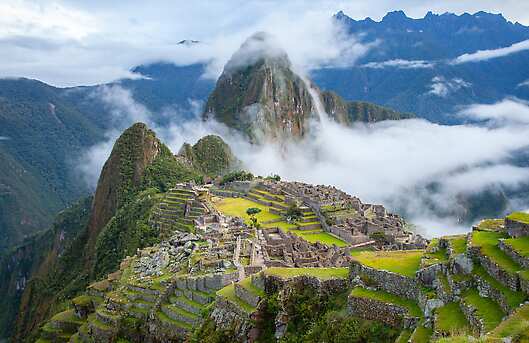 Machu Picchu on a mountaintop, surrounded by mist