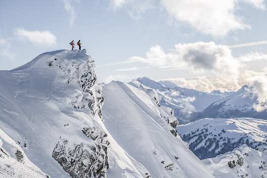 Two skiers exploring the backcountry in Whistler, Canada.