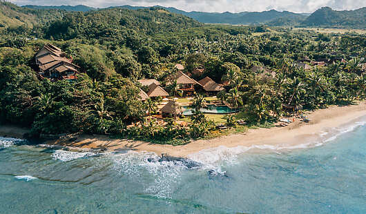 Aerial View of Nanuku Resort Fiji's Clubhouse and Main Pool along the gorgeous beachfront location