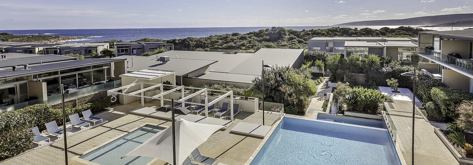 Heated infinity pool and children’s wading pool with Smiths Beach in the background. 