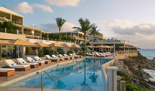 Modern suites overlooking a stunning infinity pool and the Atlantic Ocean.