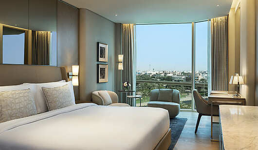 The Superior Room bedroom is complemented by the timber paneled walls and a luxurious linen fabric