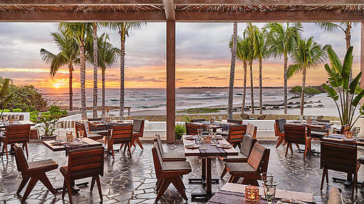 Beachside outdoor dining space at sunset 