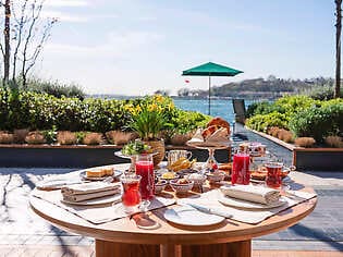 Breakfast on the terrace of The Peninsula Istanbul overlooking the Bosphorus waterfront in Istanbul, Turkey.