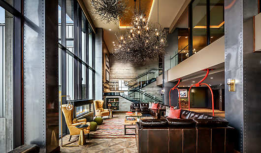 The lobby welcomes guests with floor to ceiling windows, bringing the outside in. 
