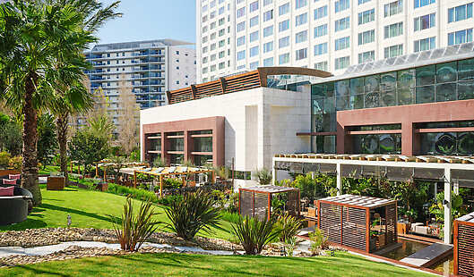 Panoramic view of the hotel terrace and garden.