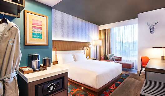 King bedroom featuring comfy bathrobes, Google Chromecast, and elevated amenities.