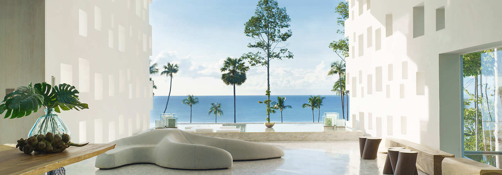 The long dramatic lobby illuminated with skylights guides the eye to a perfectly framed and breathtaking ocean view.