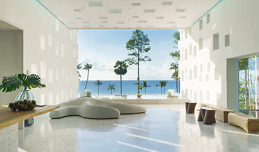 The long dramatic lobby illuminated with skylights guides the eye to a perfectly framed and breathtaking ocean view.