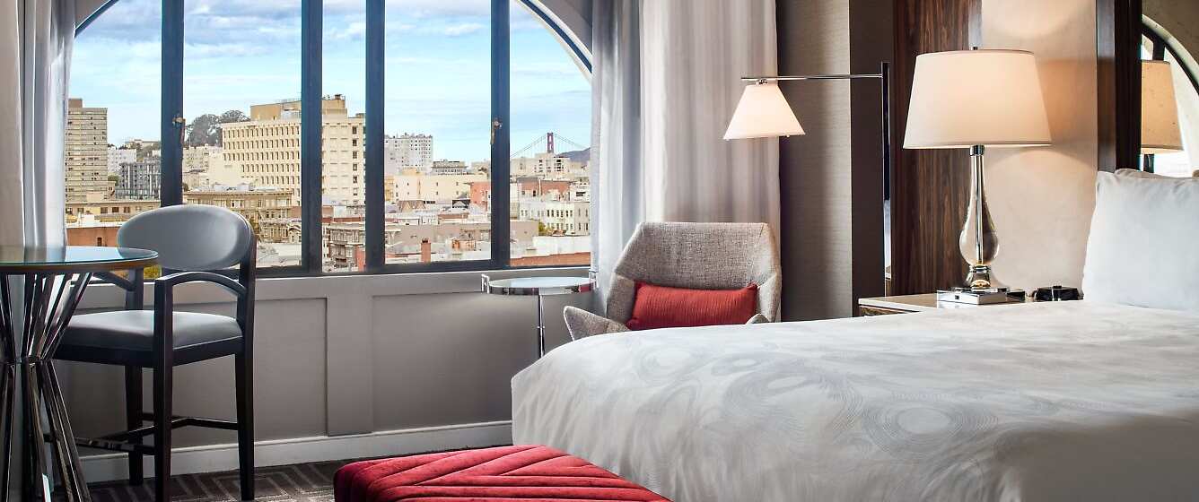 Beautiful guest rooms with iconic views of San Francisco through the unique arched windows.