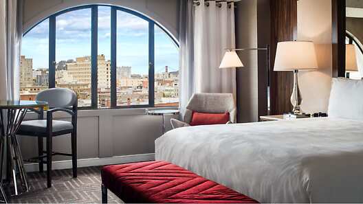 Beautiful guest rooms with iconic views of San Francisco through the unique arched windows.