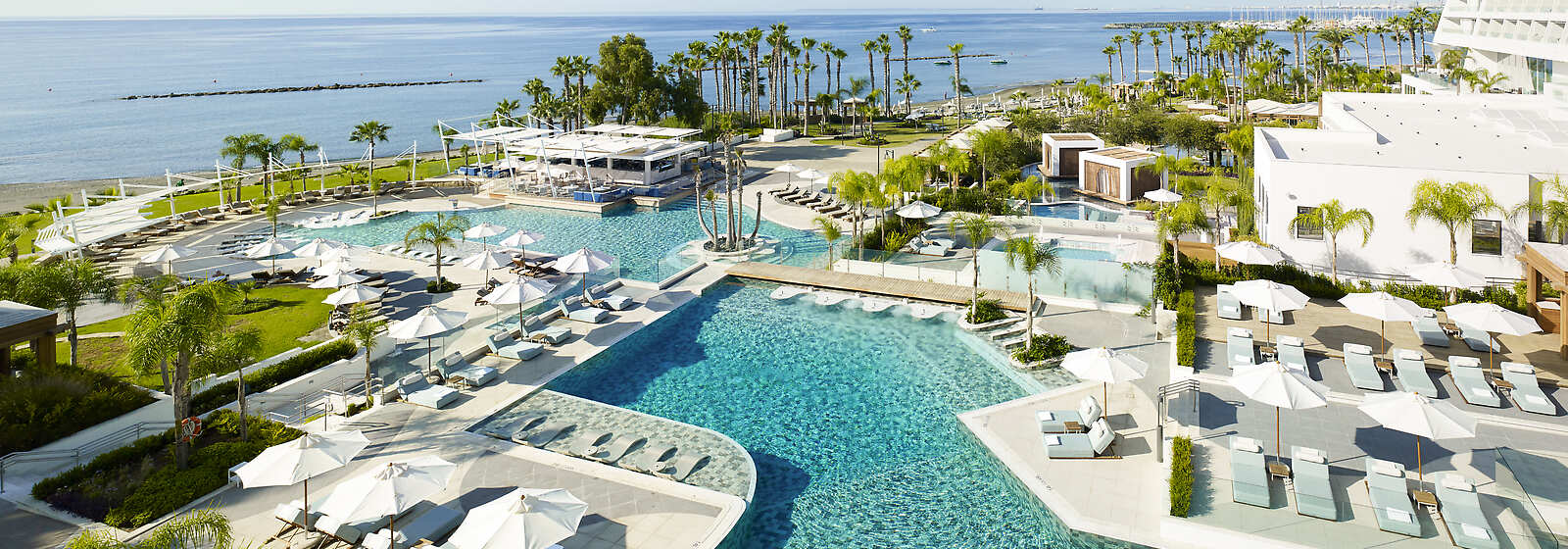 Aerial view of the Resort showing the beachfront location, the adults-only pool and Vythos bar by the seawater pool