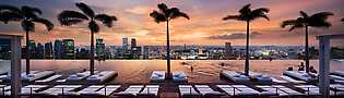 Aerial View of infinity swimming pool at Marina Bay Sands in Singapore with view of Singapore skyline.