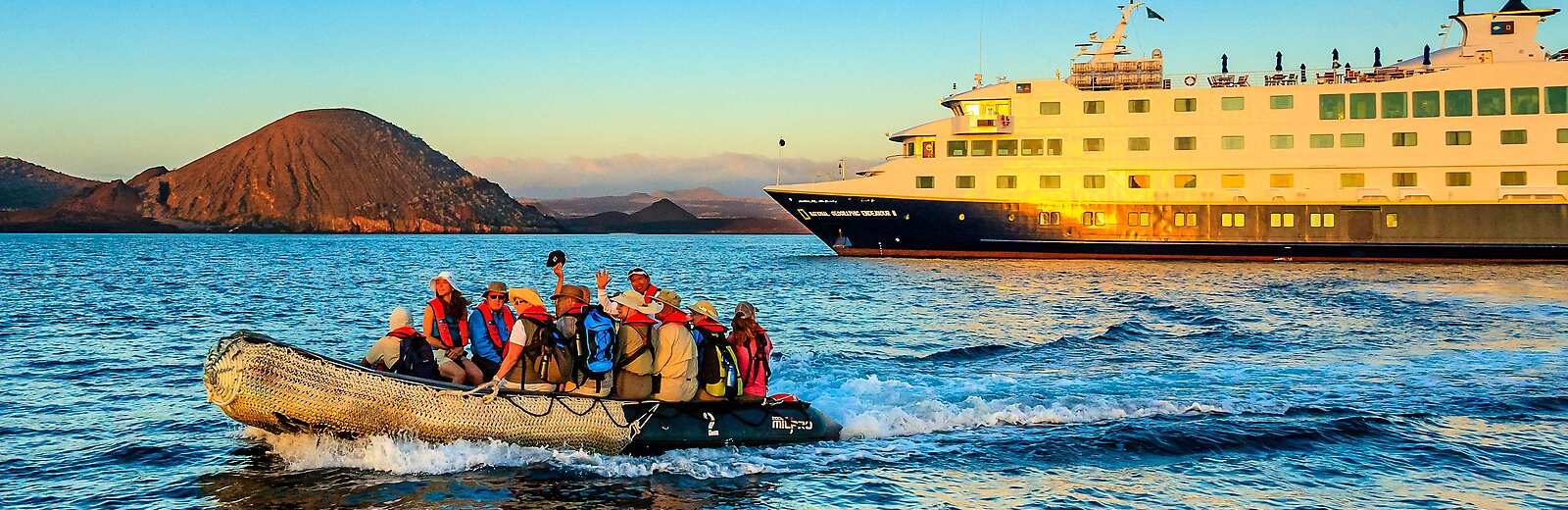 Explorers aboard a Zodiac setting off for adventure in the Galapagos islands